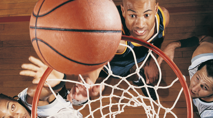 A basketball being shot towards the hoop