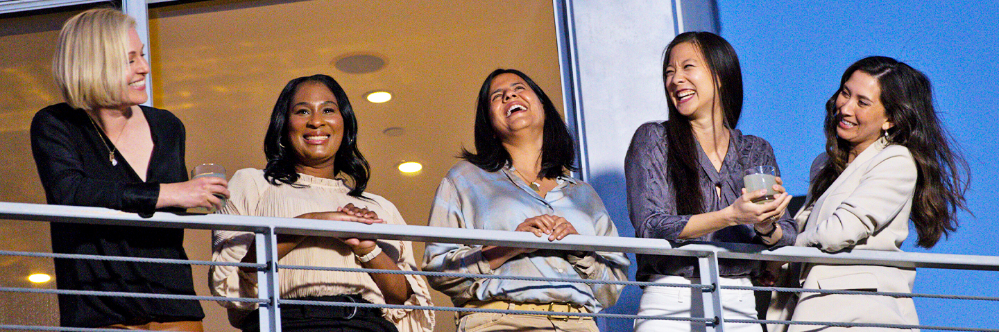 Five women standing together and smiling
